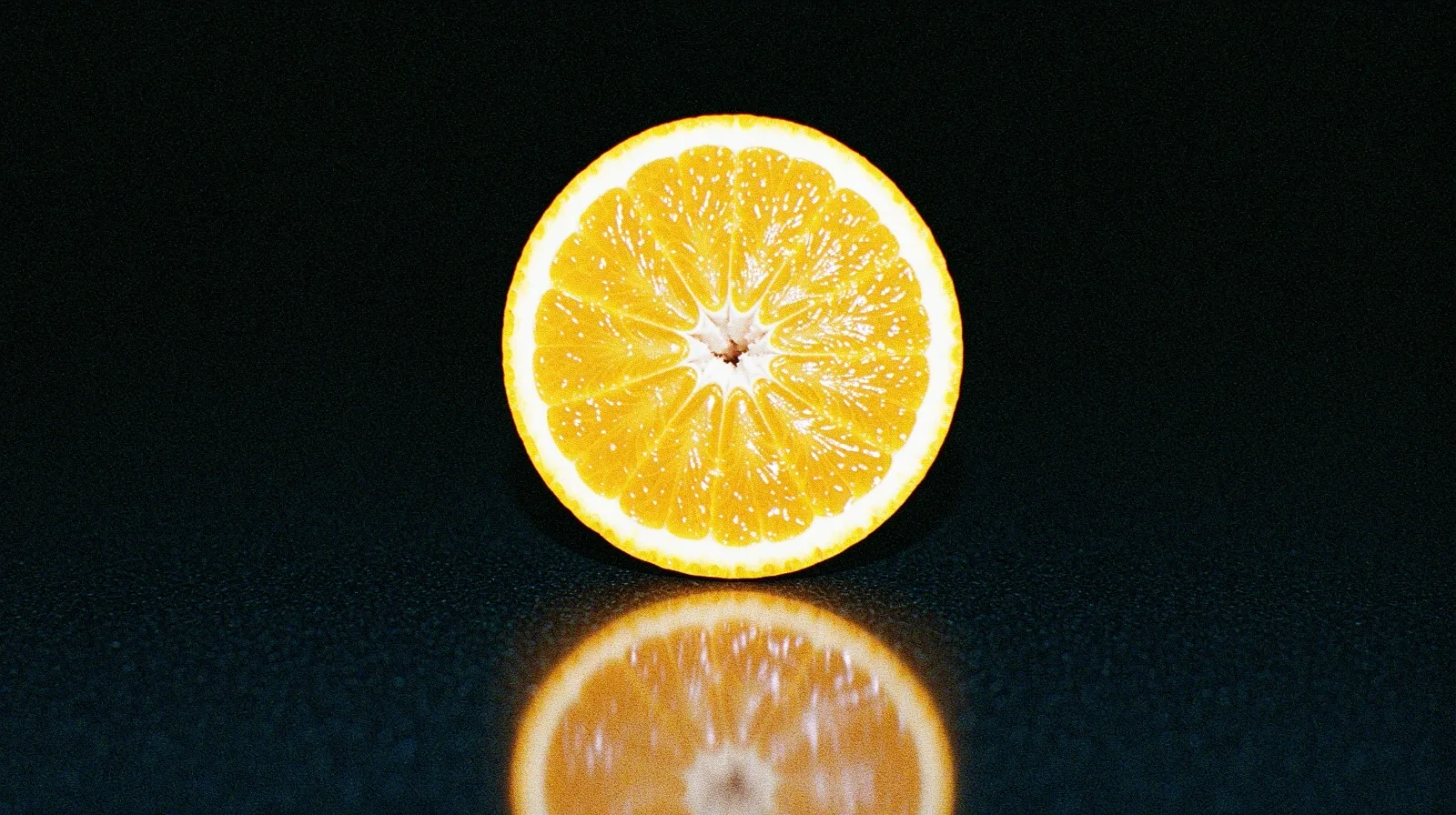Vibrant citrus fruit under dramatic lighting